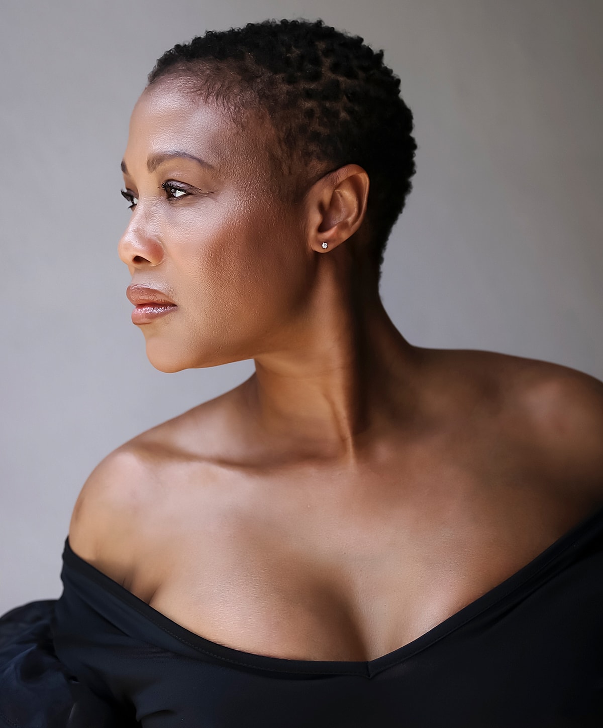 Abuja Neck Lift model with long silver hair.