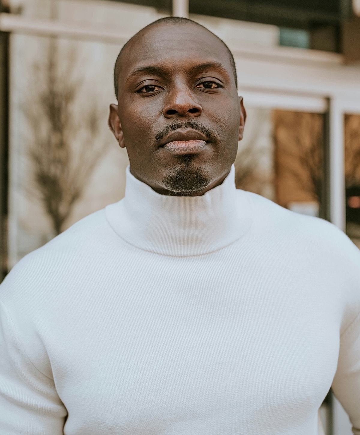 Man wearing a white turtleneck sweater.