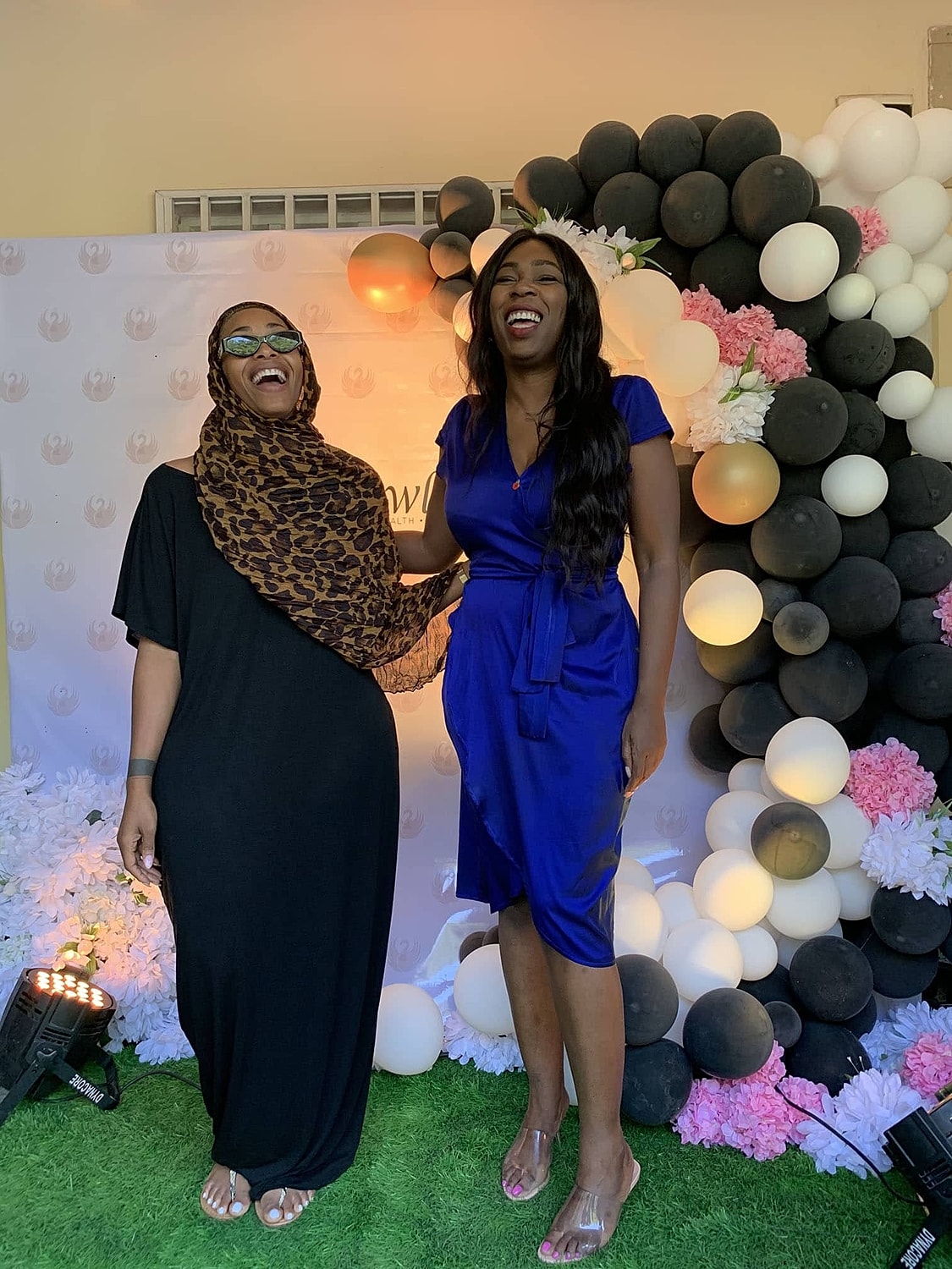 Two women laughing at a celebration event.