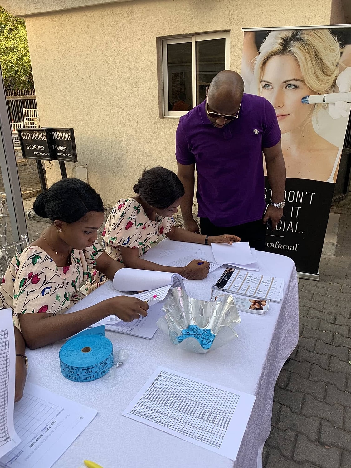Participants registering for a beauty treatment event.