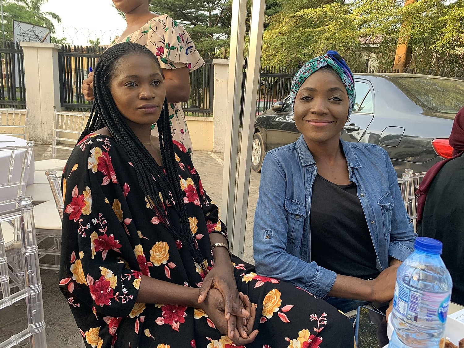 Two women enjoying a social event outdoors.