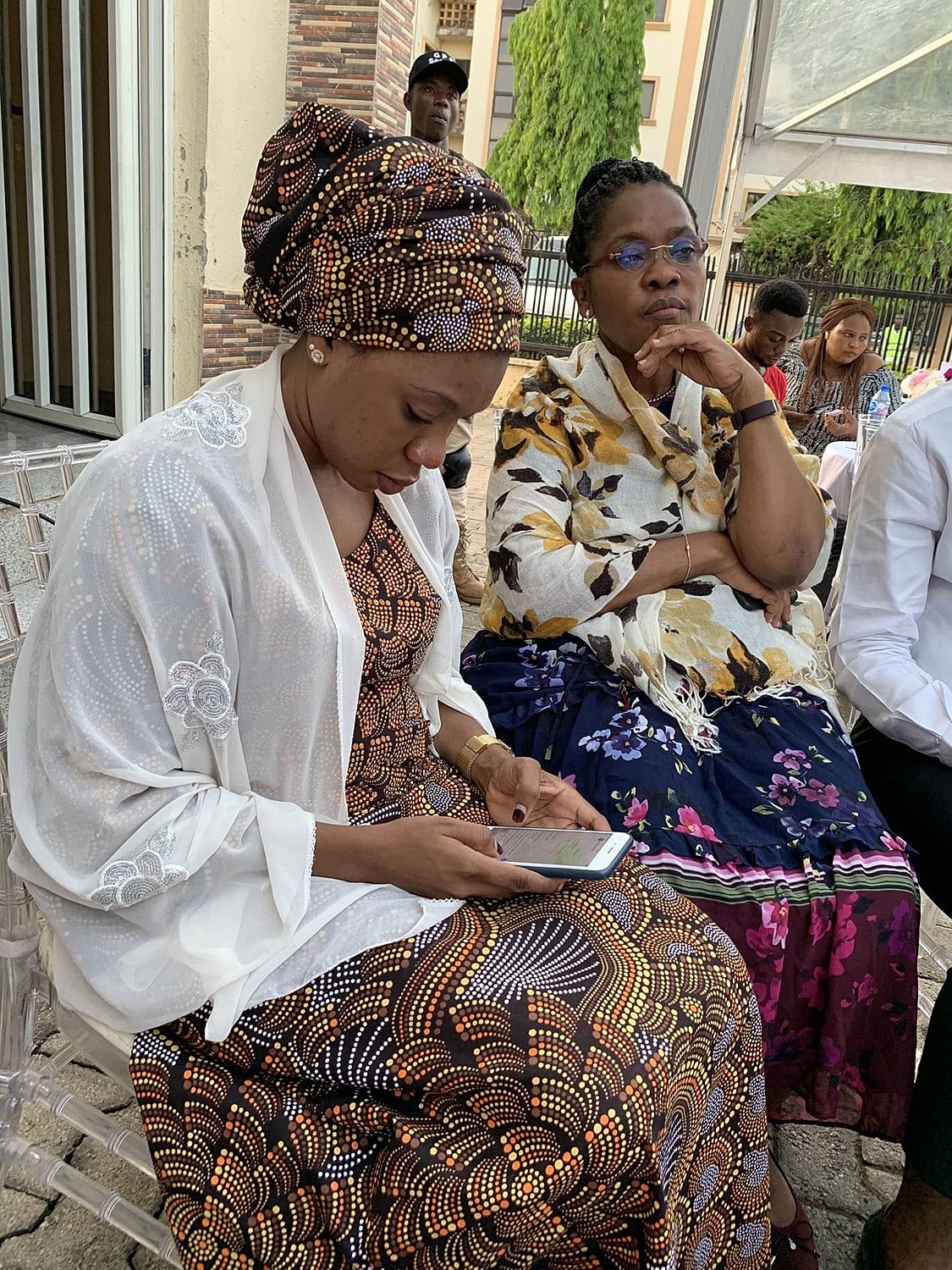 Women in traditional attire engaged in conversation.