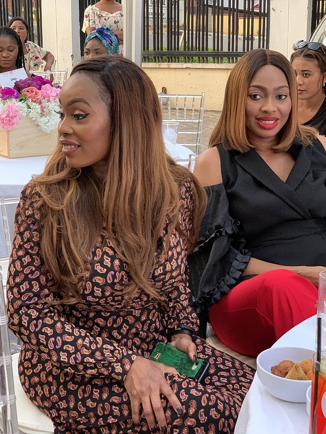 Two women enjoying a social gathering outdoors.