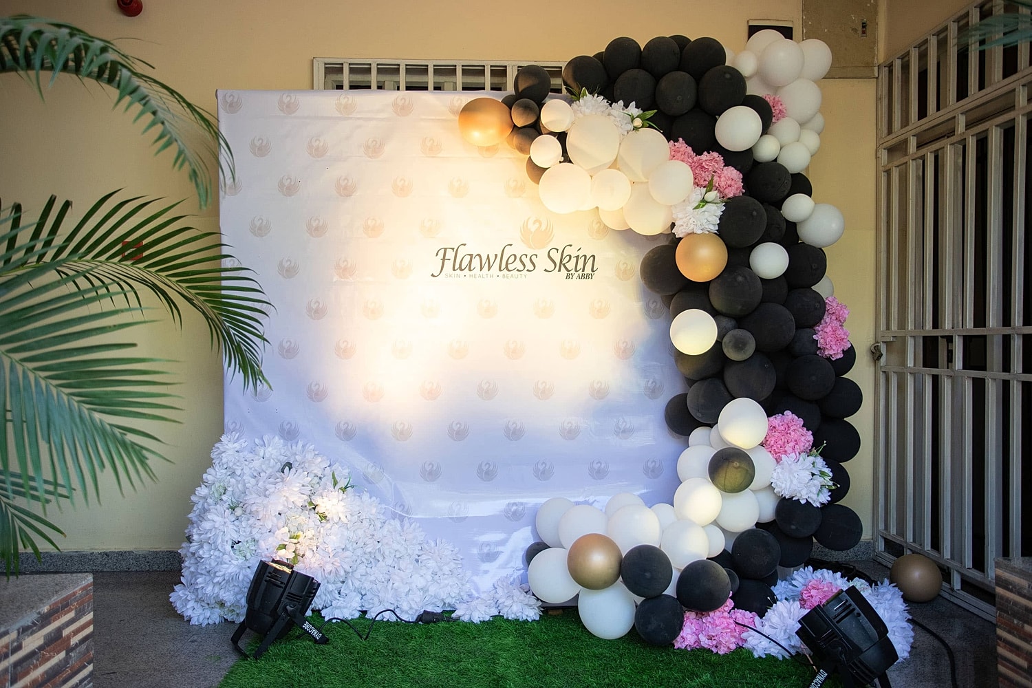 Festive balloon backdrop for Flawless Skin event.