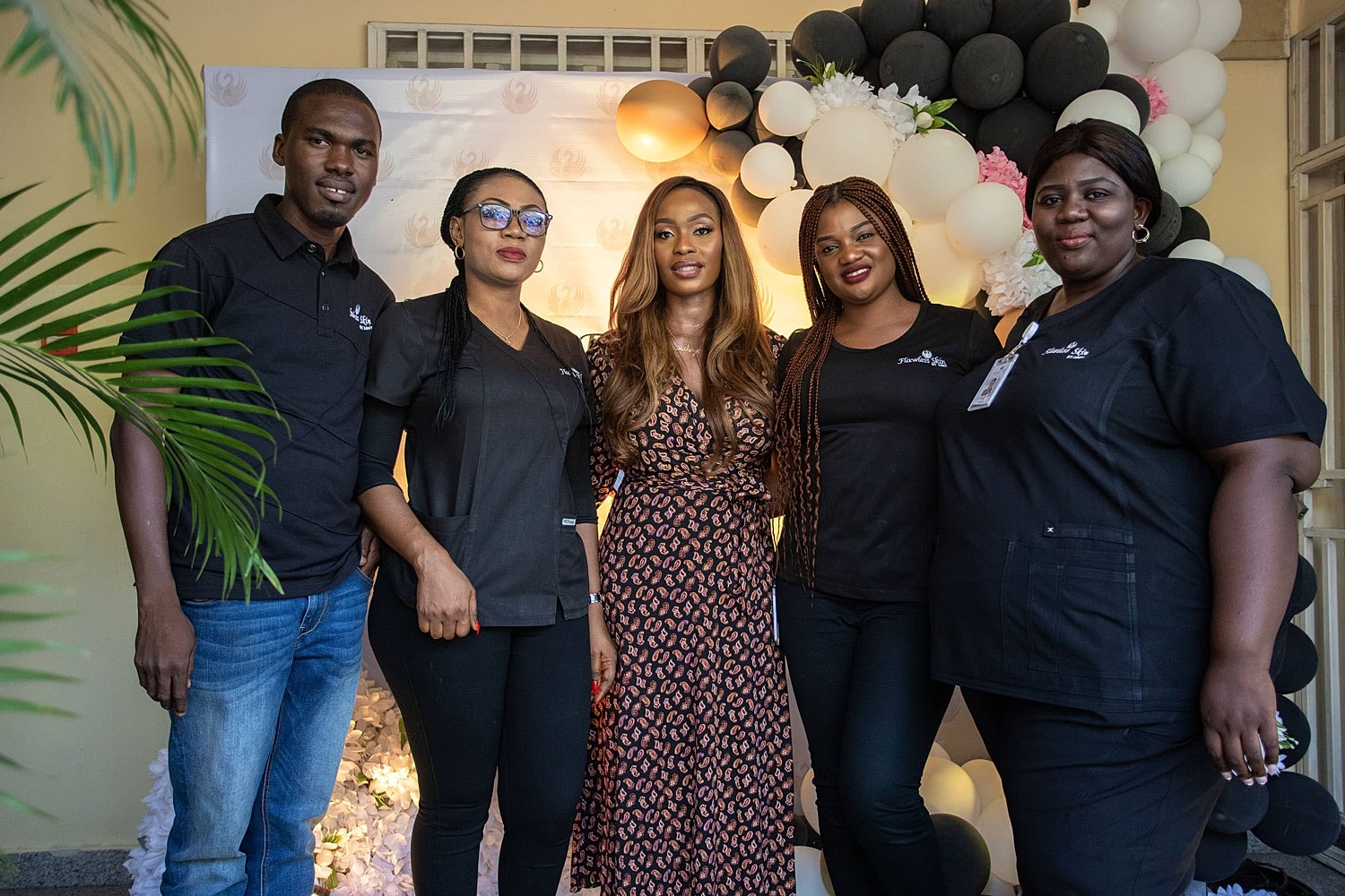 Group photo with five people at an event.