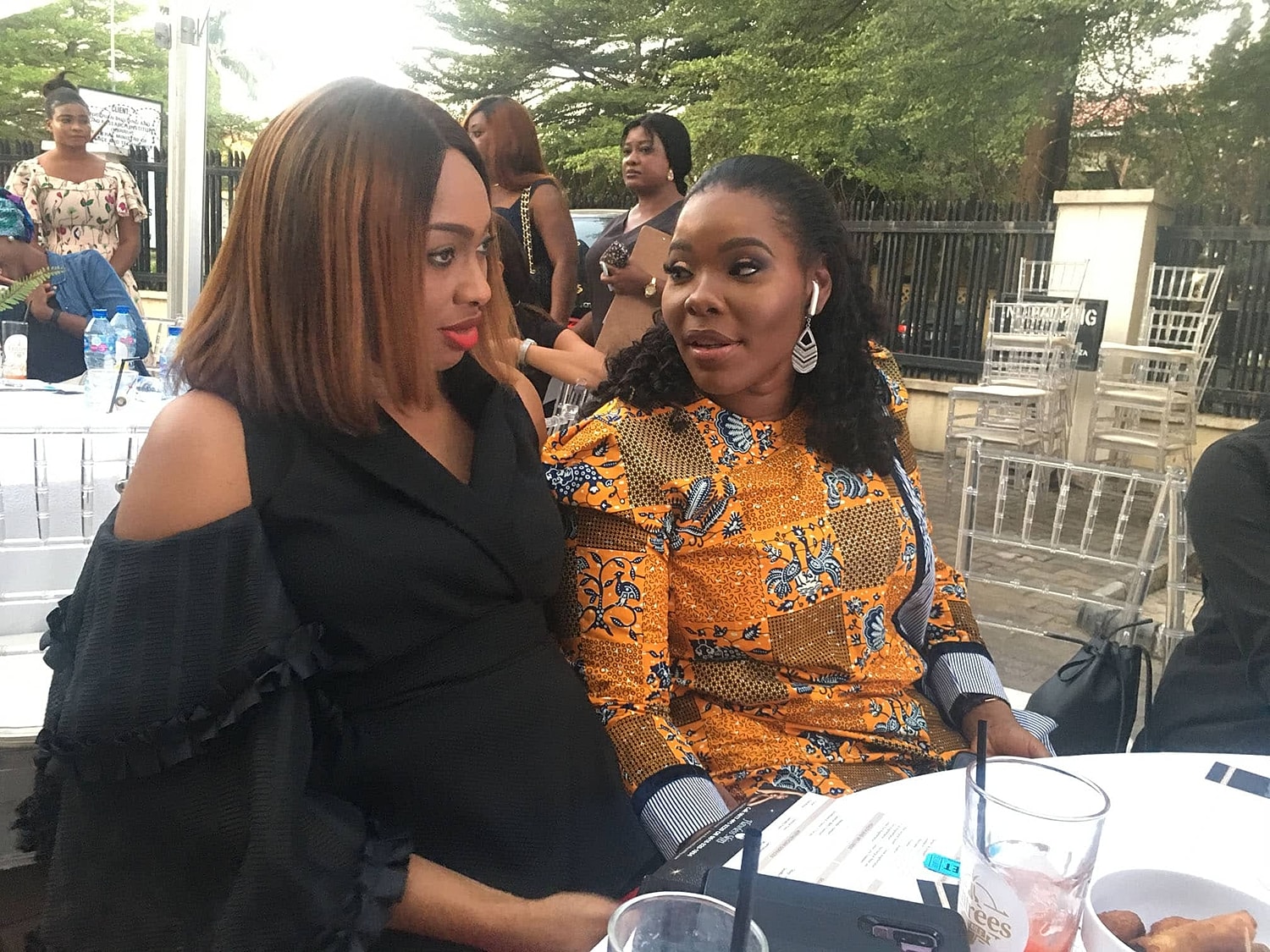 Two women engaged in conversation at an event.