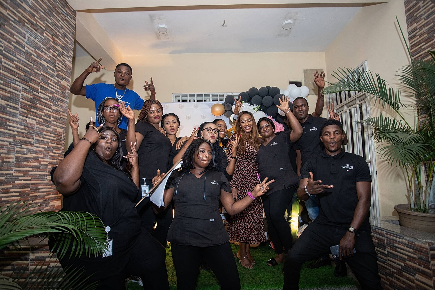 Group of people posing joyfully at event.