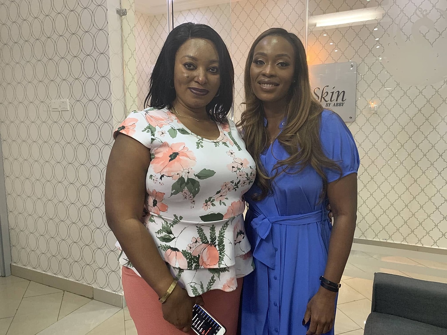 Two women posing in a professional setting.