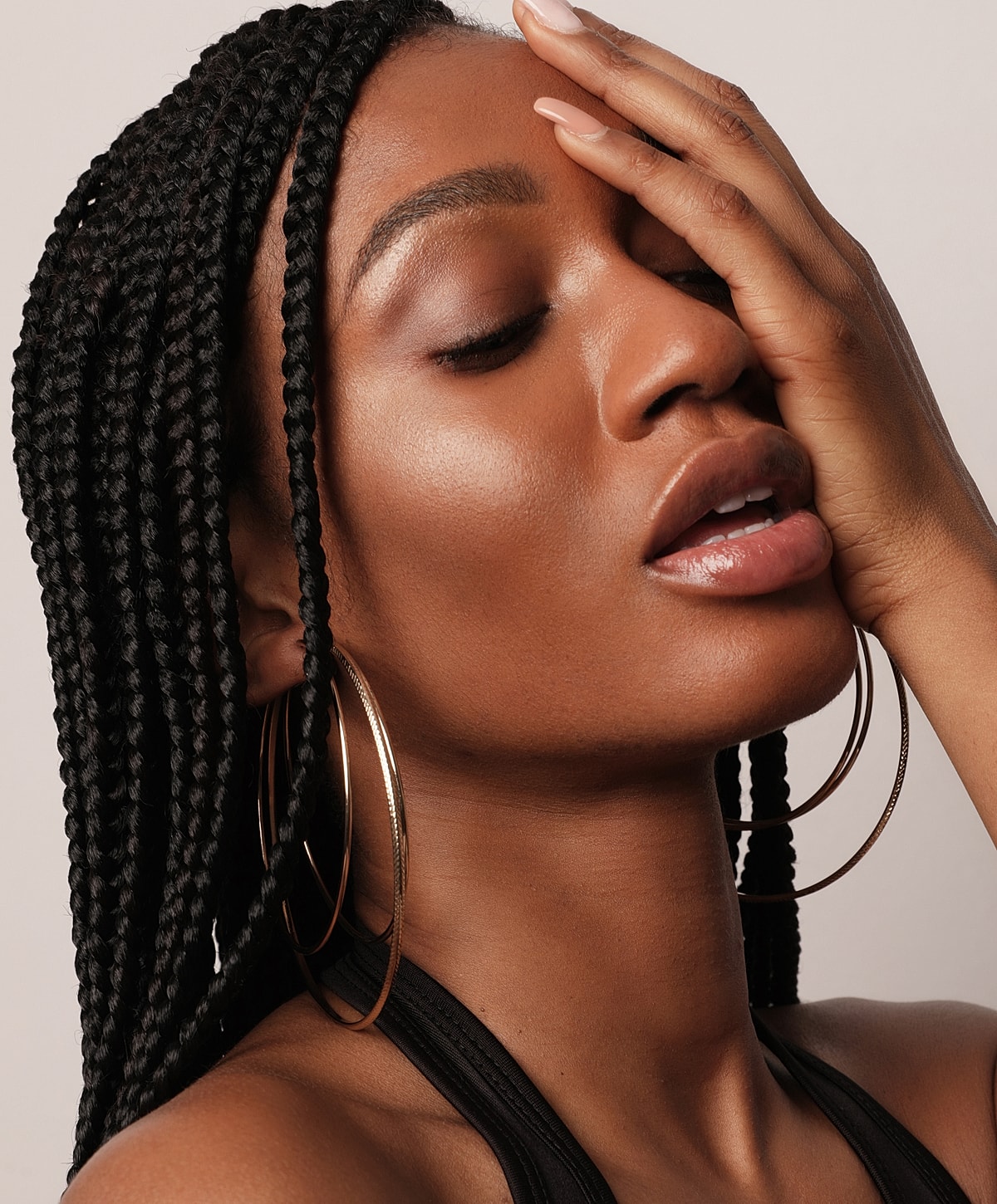 Abuja Dysport model with beautiful skin and red nail polish.