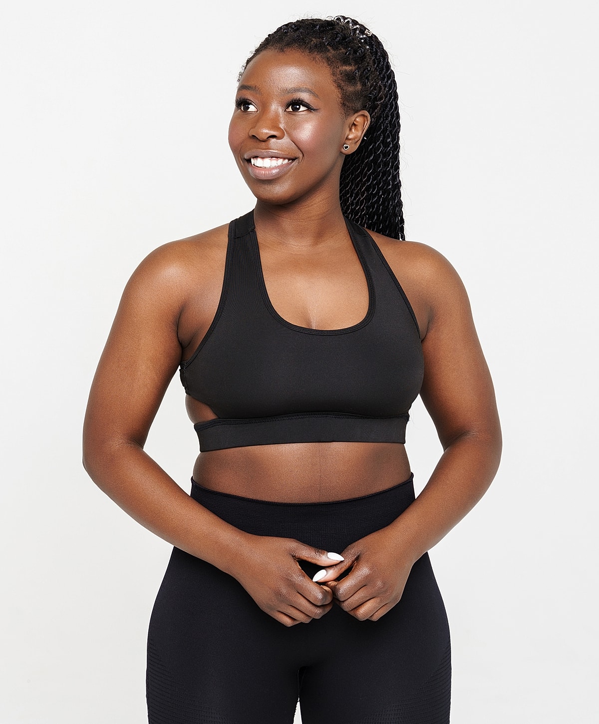 Woman with curly hair in sunset background.