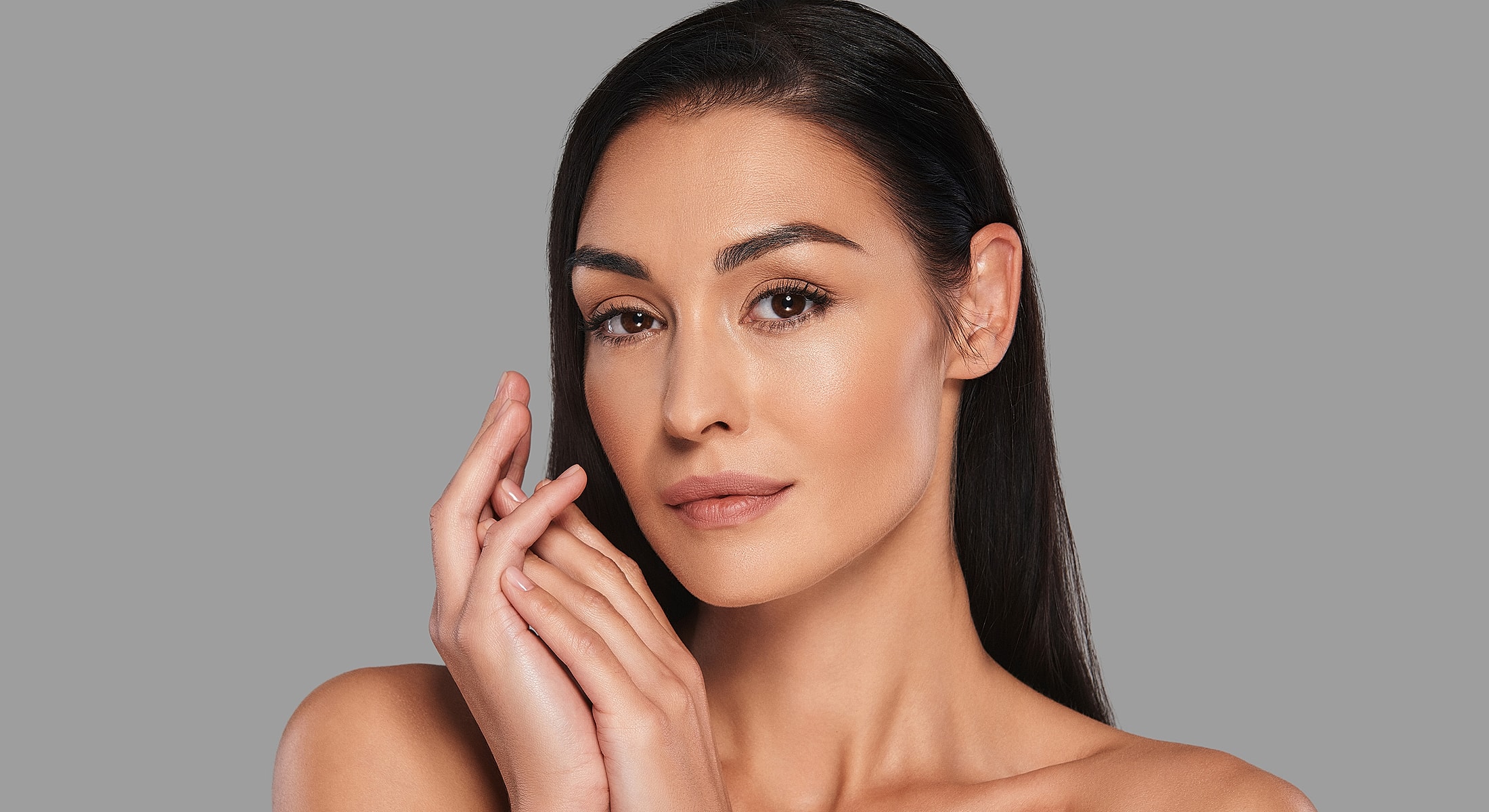 Woman with smooth skin and hands on face