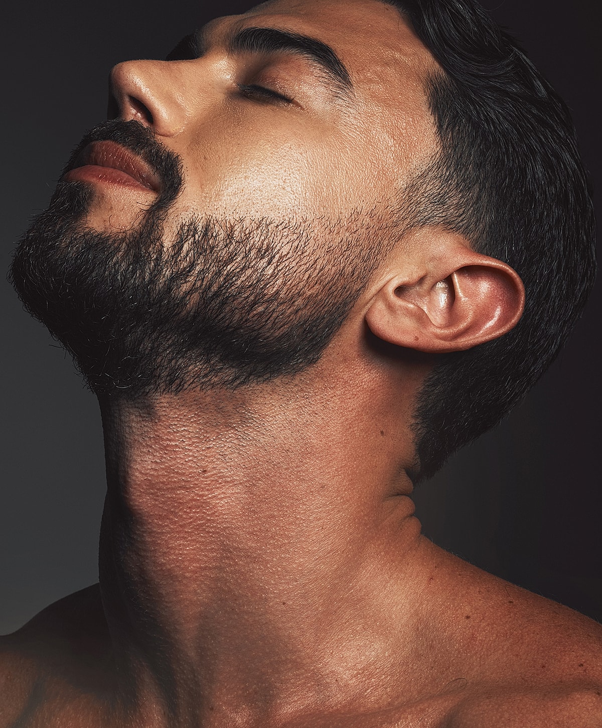 Abuja Kybella for Men model with beautiful skin and red nail polish.