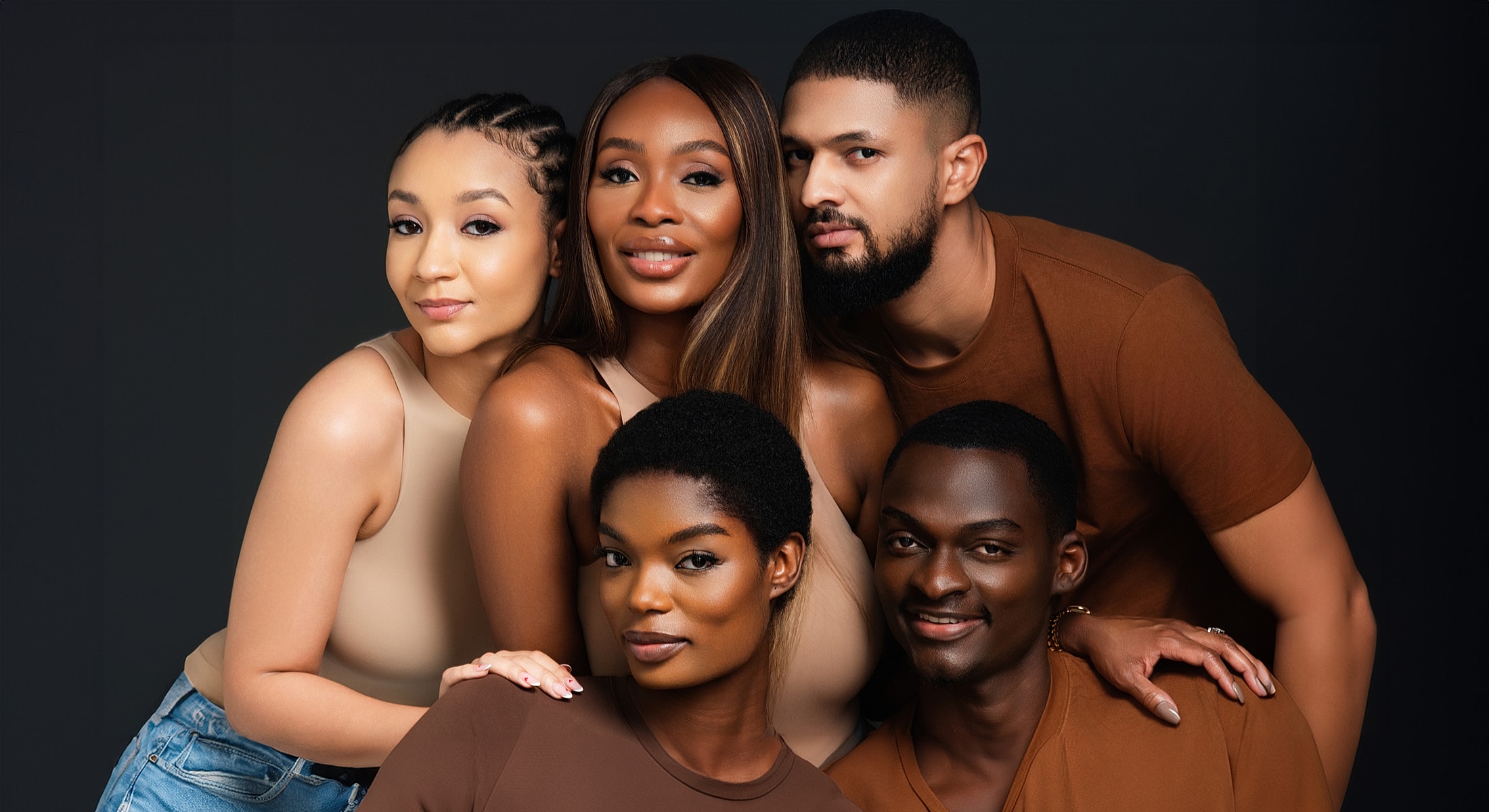 Diverse group of friends posing together joyfully.